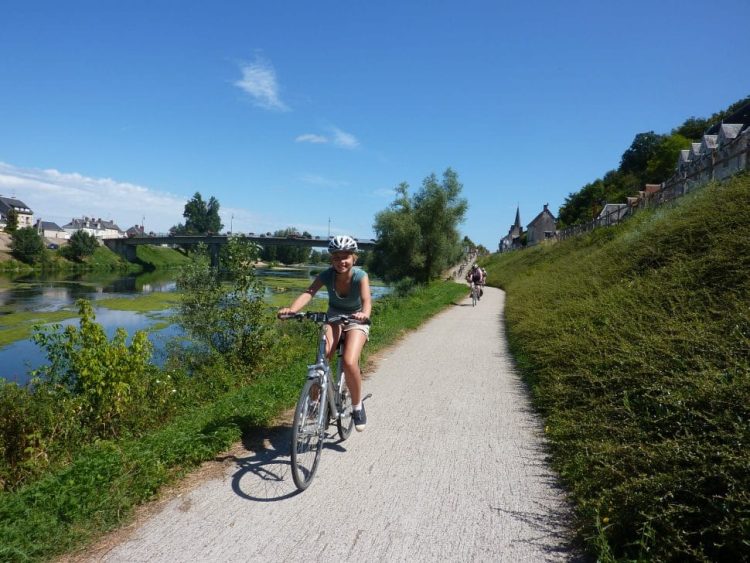 view of a cyclist on the cycle path by the river cher