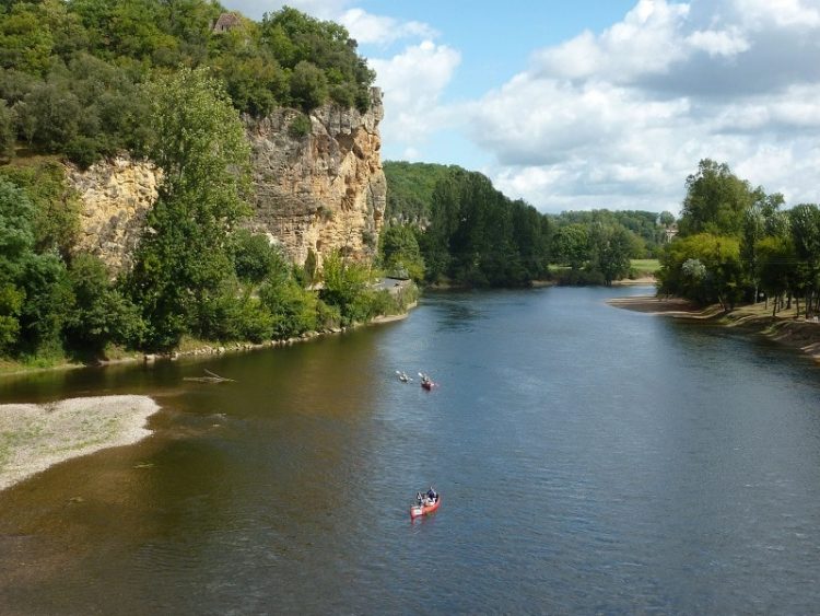 Kayaks on a river surrounded by rocks in the Dordogne