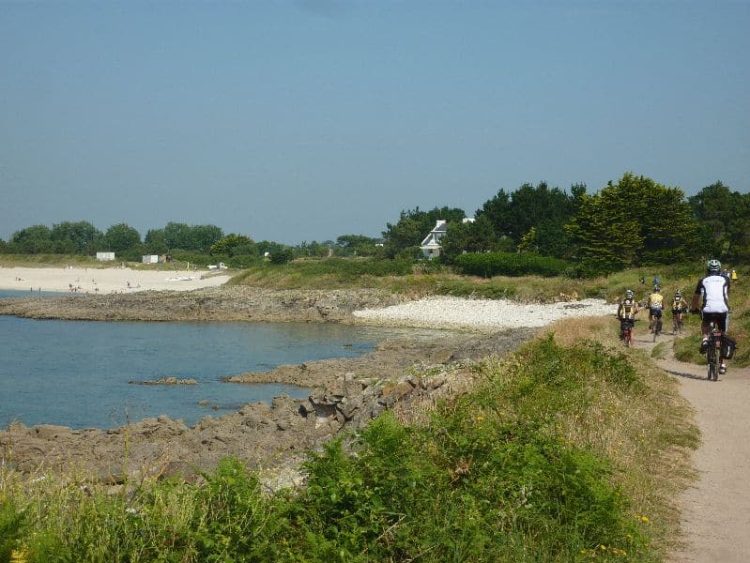 View of bike path with cyclists along the coast in Finistère